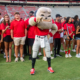 Hairy Dawg poses in front of students from the UGA Class of 2030 on Dooley Field.